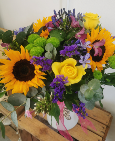 Sunny blooms eco vase - A bright mix of summer flowers in a recycled plastic eco friendly Vase decorated with a bow and wooden heart or butterfly.