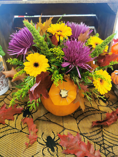 pumpkin flower arrangement - selection of bright autumn arranged in a pumpkin