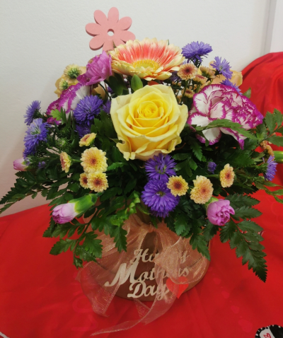 Mother's day Hatbox - A selection of peaches purples and pink flowers arranged in a Hatbox.