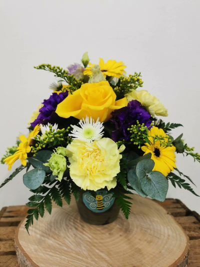 Stanley's bumble bee pot arrangement - A summery mix of yellows and purples presented in a basalt terracota pot decorated with a bumblee bee motif